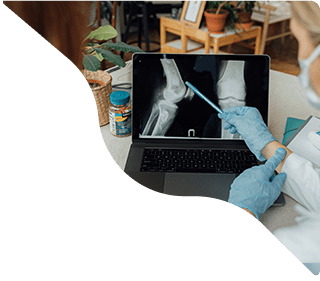 Elderly patient reviewing X-ray on laptop