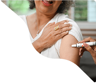 Woman applying cream on shoulder