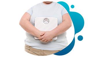 current-studies-obesity Obese man holding stomach