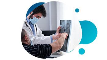 current-studies-sclerosis Doctor using tablet with patient