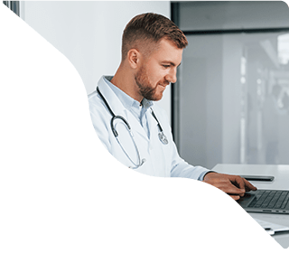 A doctor is working on the laptop