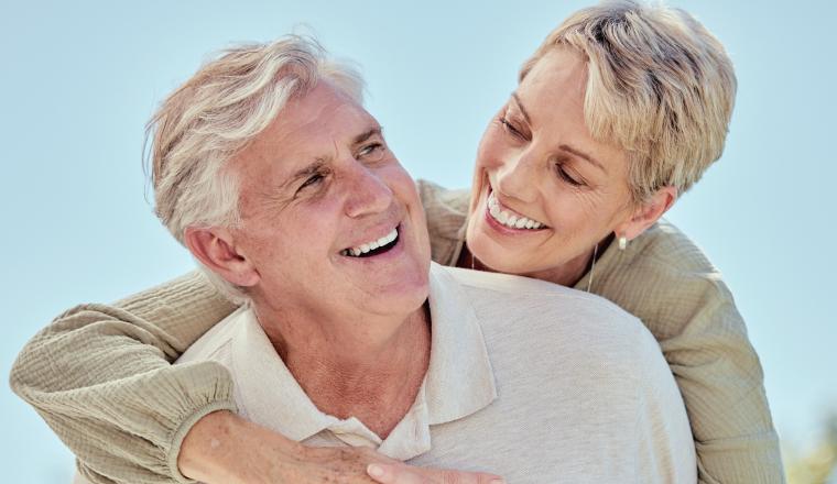 The couple is smiling happily together