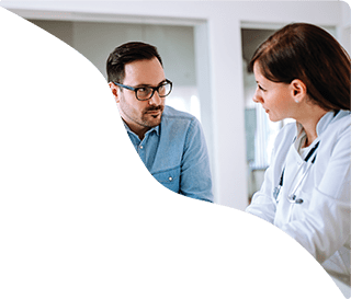 Patient consulting with female doctor about clinical trials for sciatica from lumbar disc herniation